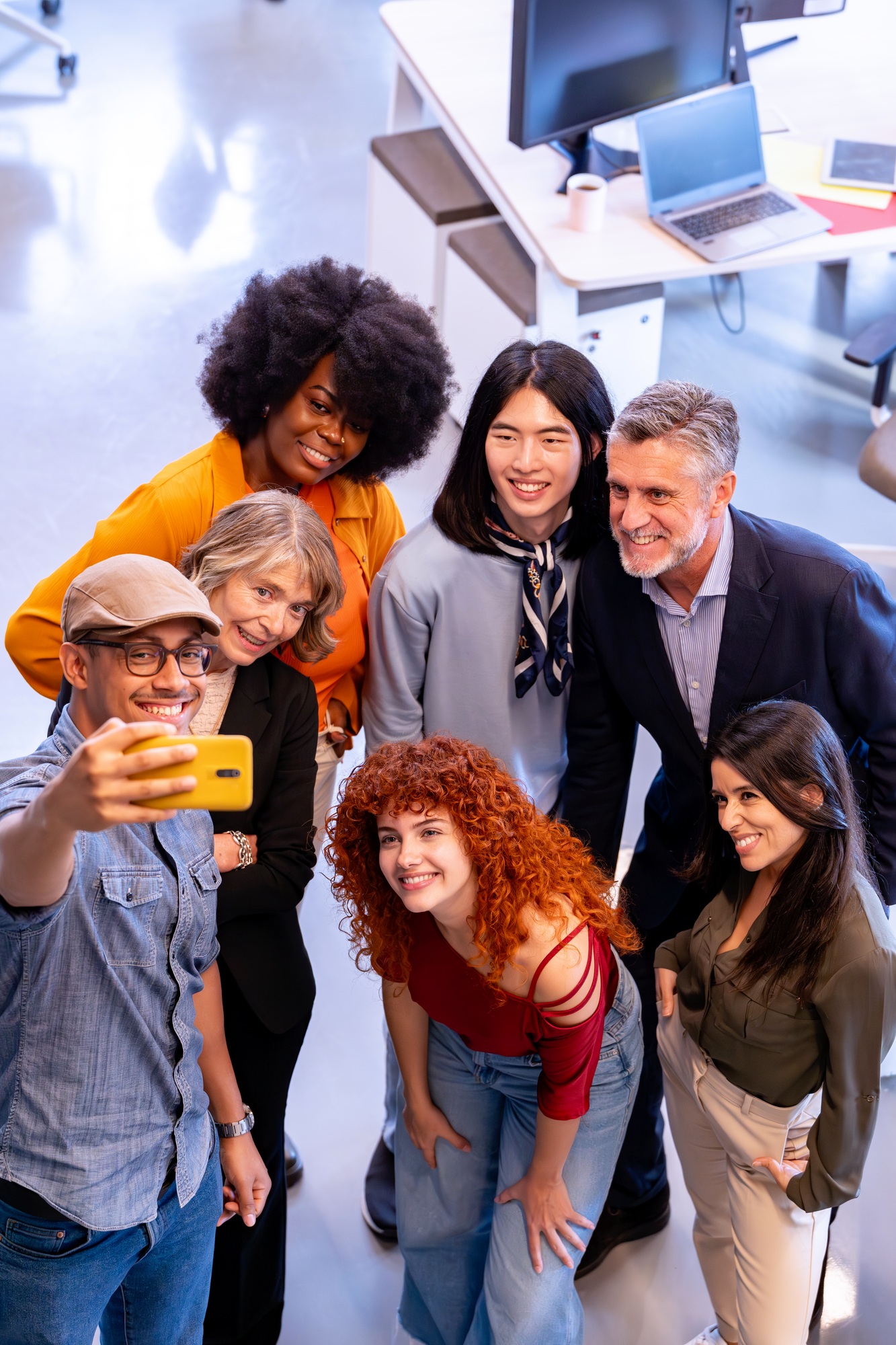 Diverse business people taking a selfie together in the office.